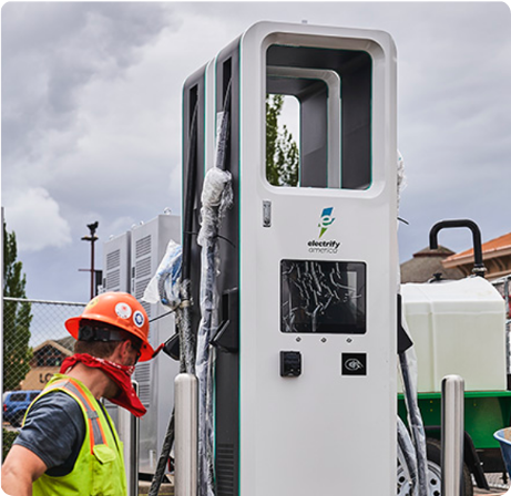 A worker installs a new charging station